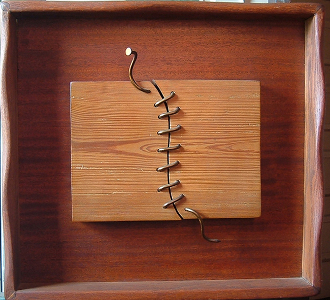 Sewn Wood, is a wall relief made of wood and metal